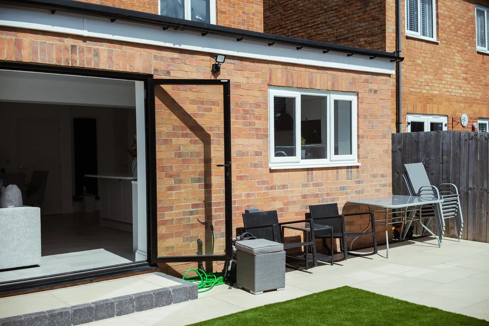 Brick rear kitchen extension with bifold doors open onto a patio, Cramlington