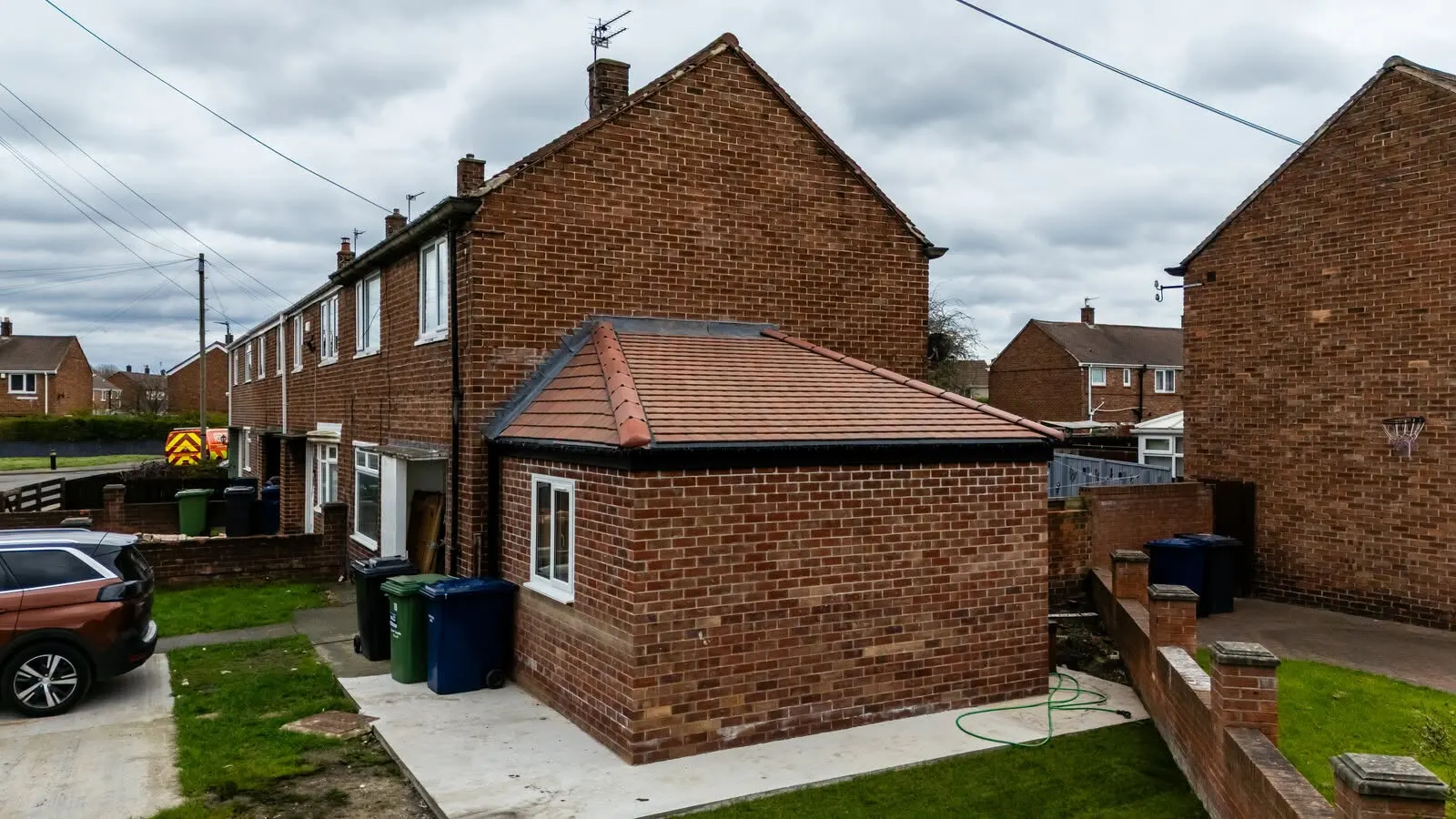 Single-storey hipped-roof brick bedroom extension to the rear, South Shields