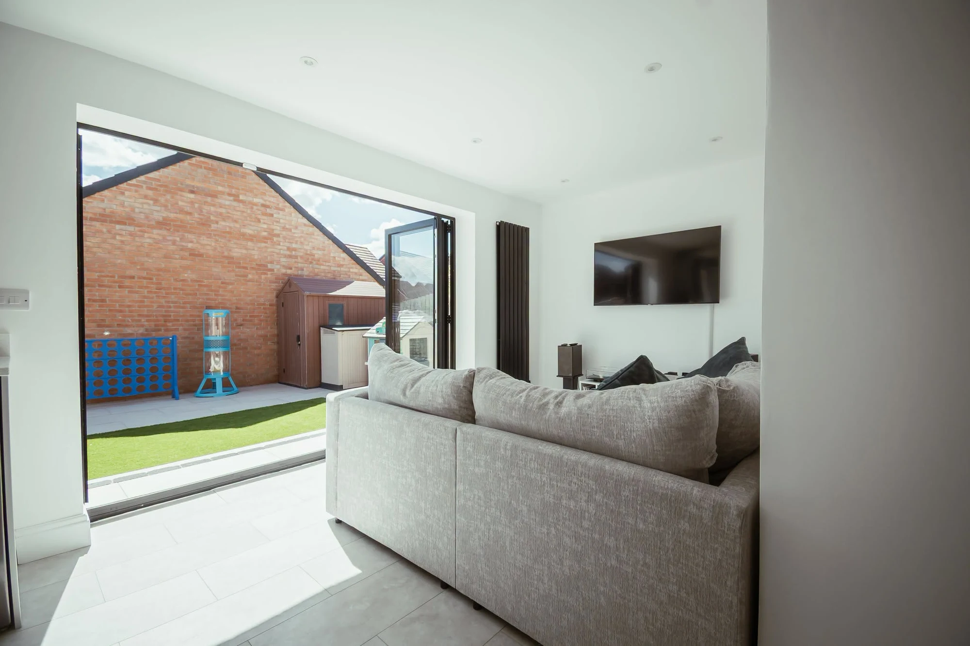 Living space looking out through bifold doors to the garden, Cramlington
